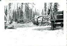 J.T. Rowan, J. Nickelson, Ken Moore loading logs with Jeep truck on Jammer