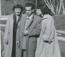 [Two women standing with a man]
