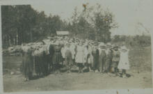 [Group of children standing with hands behind their heads]