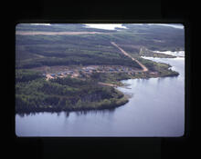 [Houses along a road by a lake]