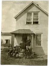 Five men in front of two-storey frame house