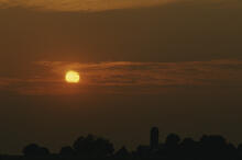 Sunset over barn and silo